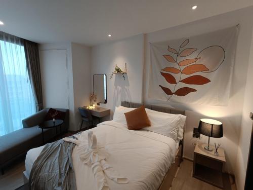 a bedroom with a bed and a table and a mirror at Downtown Chic Condo Rooftop Pool #EN797 in Pattaya Central