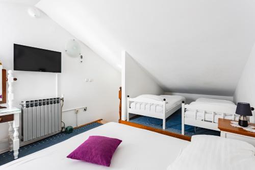 a bedroom with two beds and a tv at Villa Amigo in Podstrana