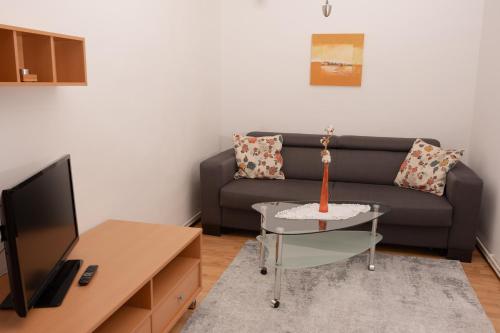 a living room with a couch and a table at Bürgerhaus Martinecz in Bad Radkersburg