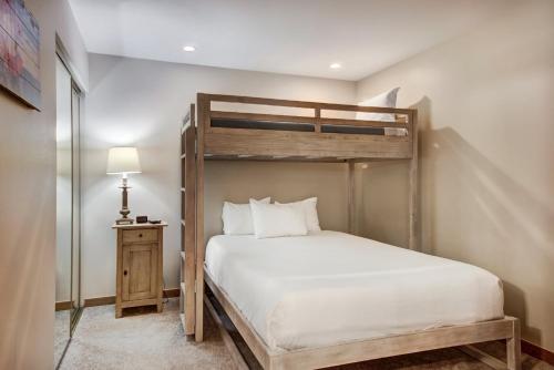 a bedroom with a wooden bunk bed in a room at Townsend Place in Beaver Creek