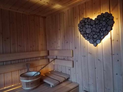 a sauna with a heart hanging on the wall at Agriturismo Al Pagan in Pigna