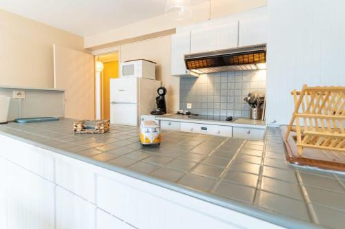 uma cozinha com armários brancos e uma bancada em Pleasant 3-rooms apartment for 6 people with parking space em Le Touquet-Paris-Plage