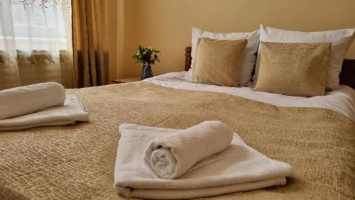 a bedroom with two beds with towels on them at Guest House David's B&B in Gyumri