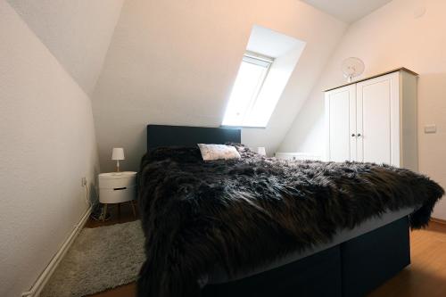 a bedroom with a bed with a black blanket at Meerzeit in Schülp