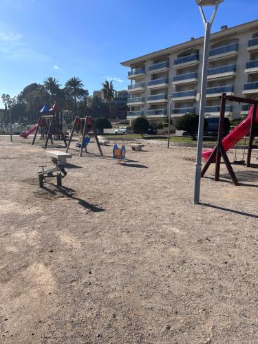 a group of playground equipment in a park at Apartamento bahía in Miami Platja
