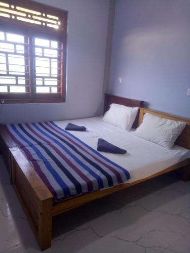 a bedroom with a large bed with a wooden frame at Billiards villa in Trincomalee