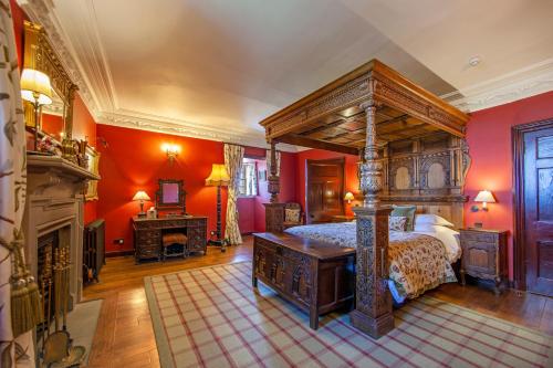 a bedroom with a canopy bed and a fireplace at Barcaldine Castle in Oban