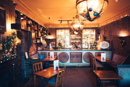 a restaurant with tables and chairs and a bar at The Coledale Inn in Keswick