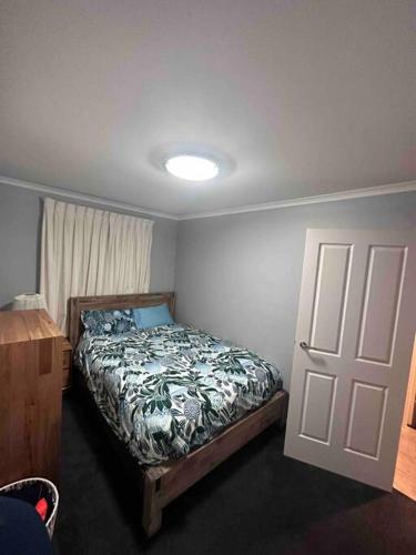 a bedroom with a bed and a white door at Resort style home pool spa sauna in Phillip