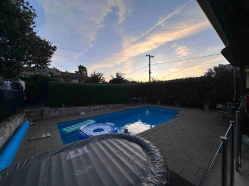 a small swimming pool in a yard with a sunset at Resort style home pool spa sauna in Phillip