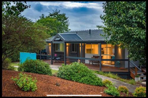 a home with a large deck and a house at Resort style home pool spa sauna in Phillip