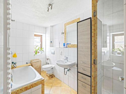 a bathroom with a tub and a toilet and a sink at Fully equipped apartments in Gerstetten in Gerstetten