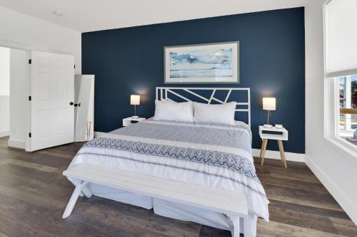 a bedroom with a large bed with a blue wall at Simply Adventurous in Mexico Beach