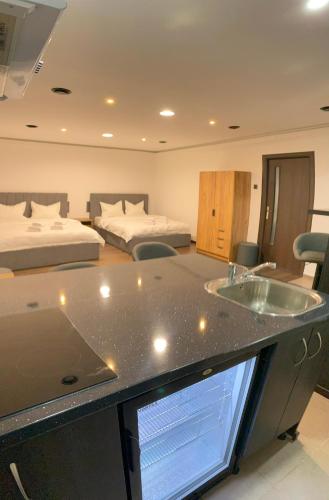 a hotel room with a sink and two beds at Casa Sofia in Satu Mare