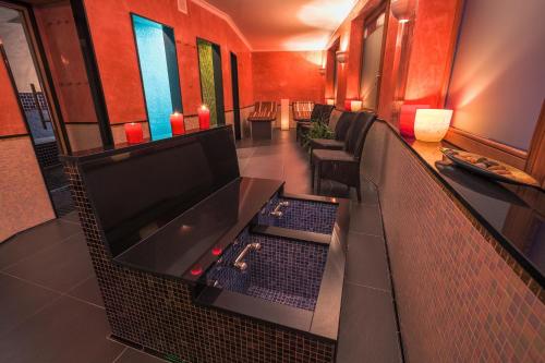 a room with a tv and a table and chairs at Hotel San Gian in St. Moritz