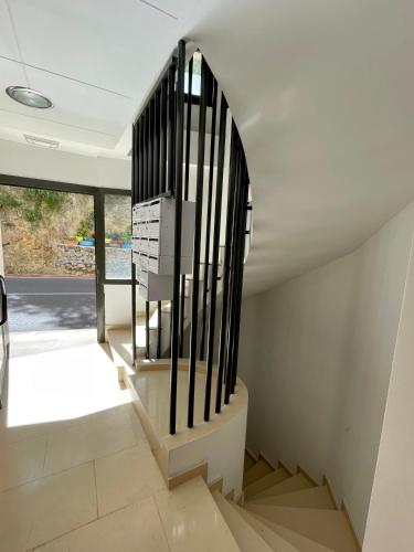 a staircase with black railings in a house at Apartamento vacacional en Lucena del Cid - Bajo C Ref 048 in Lucena del Cid