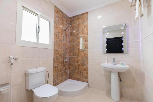 a bathroom with a toilet and a sink at Lavent Park Hotel Suites in Jeddah