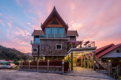 a house with a tower on top at sunset at Villa Stan in Kamala Beach