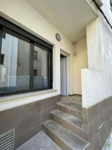 a building with stairs in front of a window at Holiday appartement in Lucena del Cid- Basement A Ref 049 in Lucena del Cid