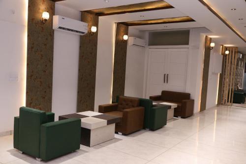 a lobby with couches and tables in a building at K K RESIDENCY in Yamunānagar