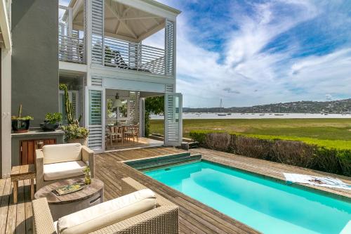 a house with a swimming pool and a patio at Sunset Lane Fairmile Point in Knysna
