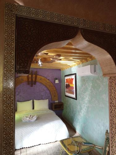 a bedroom with a large bed in a room at RIAD ESMERALDA By Dar Ouezzani in Rabat