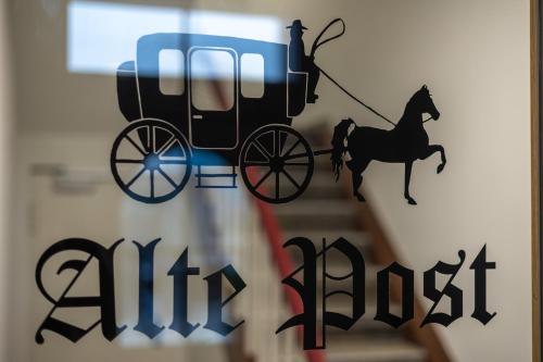 a figurine of a horse drawn carriage on a wall at Gasthaus Alte Post in Kirchzarten