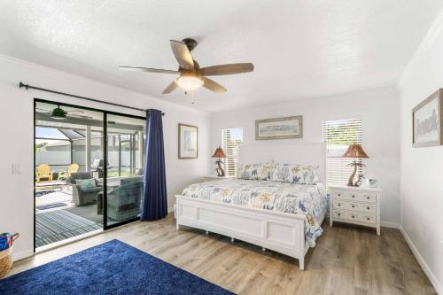a bedroom with a bed and a ceiling fan at Villa Turtle Shell in Englewood