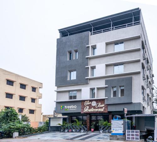 un edificio alto gris con un cartel delante en Treebo Trend A1 Residency - Hingna T Point, en Nagpur