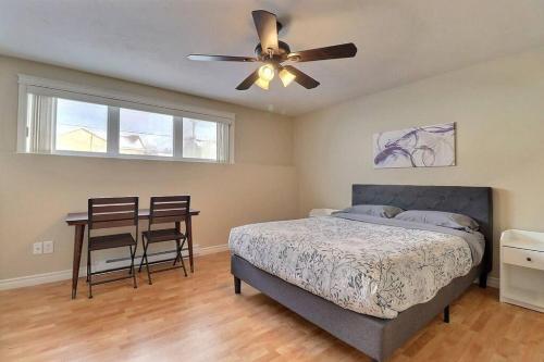 een slaapkamer met een bed en een plafondventilator bij Home in Central Moncton WFH NBCC in Moncton