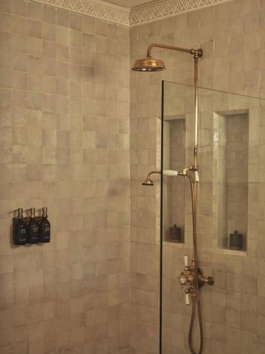 a bathroom with a shower with a glass door at IZZA Marrakech in Marrakech