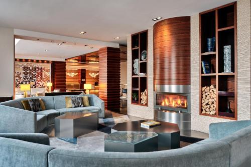 a living room with couches and a fireplace at Sheraton Sopot Hotel in Sopot