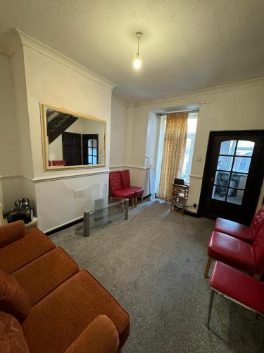 a living room with a couch and a table at 316 Ripponden home in Moorside