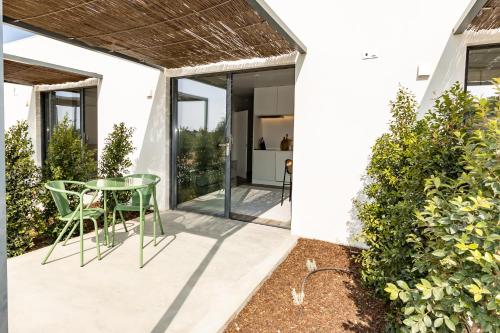 a glass table on the patio of a house at Quinta da Amendoeira - Évora - The Farmhouse in Évora