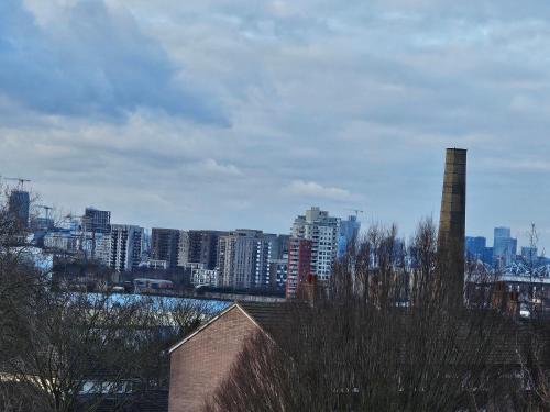 a view of a city with a smoke stack at Umbrella Properties London Woolwich in London