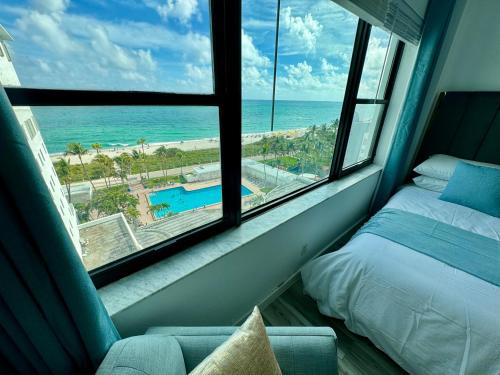 a bedroom with a bed and a view of the ocean at Directly on the Beach with Pool & Ocean View in Miami Beach