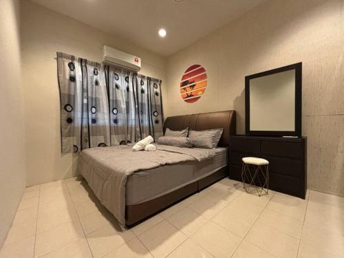 a bedroom with a large bed and a mirror at Camping Homestay Kluang in Kluang