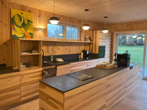a kitchen with wooden cabinets and a counter top at B&B Zirbenduft in Ribnitz-Damgarten