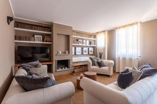 a living room with two couches and a tv at Suite Alzaia by iCasamia it in Milan