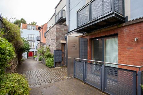 un callejón con balcón en un edificio de ladrillo en higgihaus Cabot Mews #40 Sunday - Friday Central Location, en Bristol