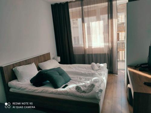 a bed in a room with a window at Tribu apartment 204 in Bakuriani