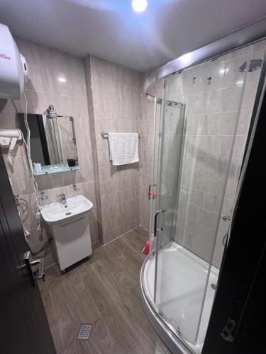 a bathroom with a shower and a sink at Tribu apartment 204 in Bakuriani