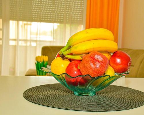 a glass bowl of fruit on a table at Apartman Lux 5- private parking in Sombor