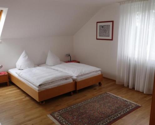 a bedroom with a bed and a rug on the floor at Haus Wörle in Nonnenhorn