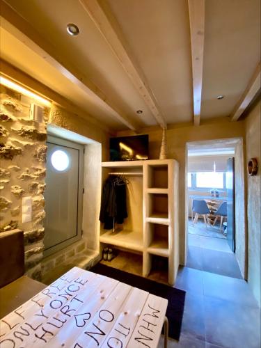 a room with a room with a table and a room with a door at D&P Cell Oneiro. in Kalavrita
