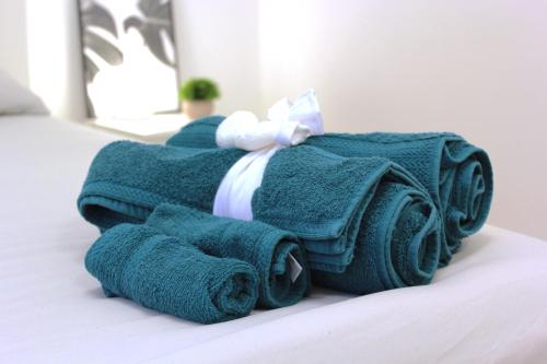 a pile of towels sitting on top of a bed at La Corte dei Creativi Lussuoso in Centro in Milan