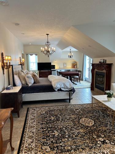 a living room with a bed and a piano at Norfolk Guest House Inn in Guelph