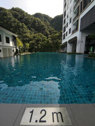 a swimming pool with a sign in the water at Onsen Studio @ Lost World of Tambun in Tambun