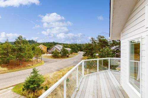 a balcony with a view of a house at The Capella in Pacific City