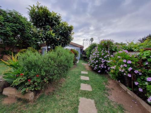 a garden with colorful flowers and a pathway at Casa Jade in Quintero